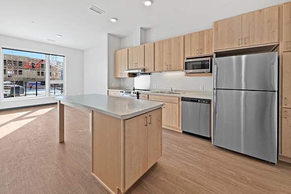 A kitchen with wooden cabinets and white appliances.