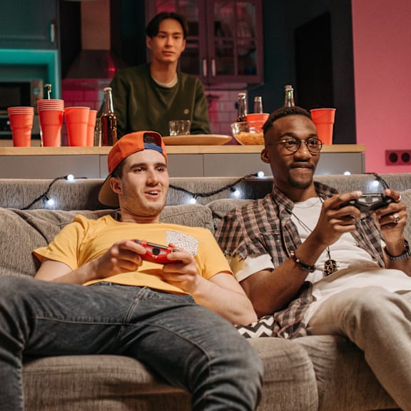 East Lansing Apartments | Students at Michigan State University play games in apartment