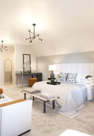 a bedroom with a bed and a chair in a room
