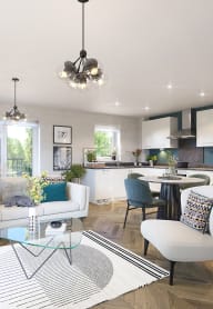 an open plan living room and kitchen with a white sofa and chairs and a glass coffee table