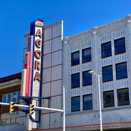 A tall building with a sign that says ACORE on it. at Life At Agora Apartments, Cleveland, Ohio