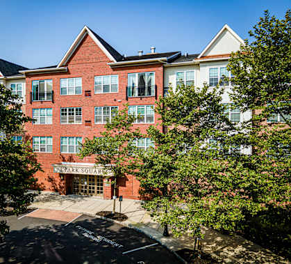 A red brick building with a sign that says Park Square.