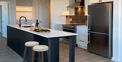a kitchen with a center island with two stools