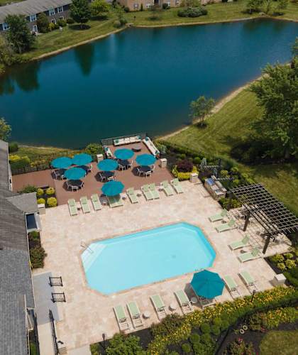 a view of the pool and lake from above