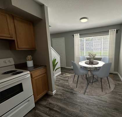 a kitchen and dining room with a table and chairs