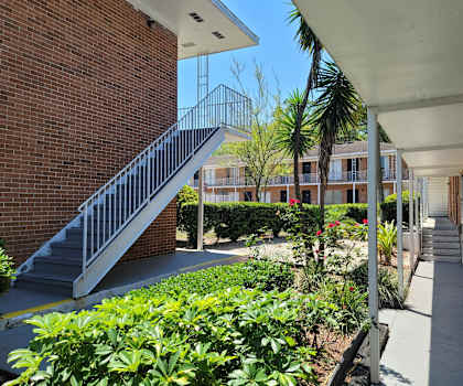 A staircase with a metal railing leads up to a building.