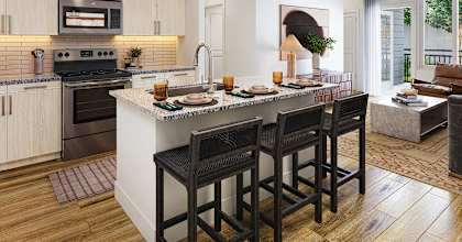 A kitchen with a bar area and a dining table.