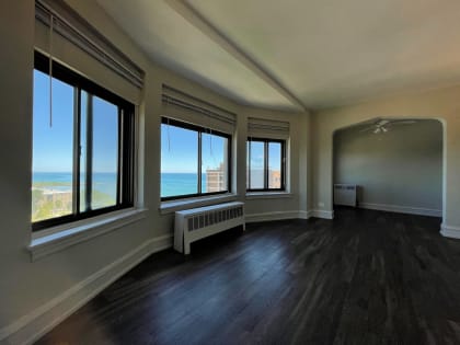 an empty living room with a view of the ocean  at 1033 W Loyola, Illinois