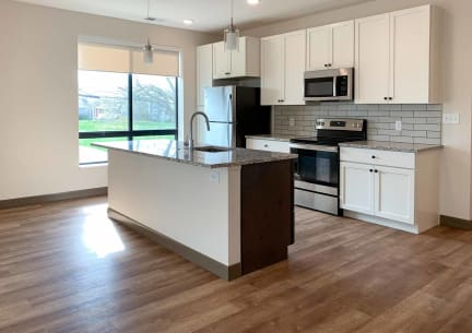 a kitchen with a stainless steel stove and a microwave