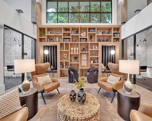 a living room filled with furniture and a bookshelf