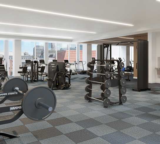 A gym with a variety of equipment including weights and machines.