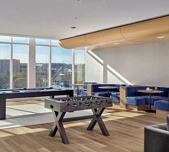 A pool table in a room with a view of the city.
