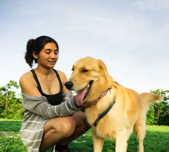 a woman and her dog in a park