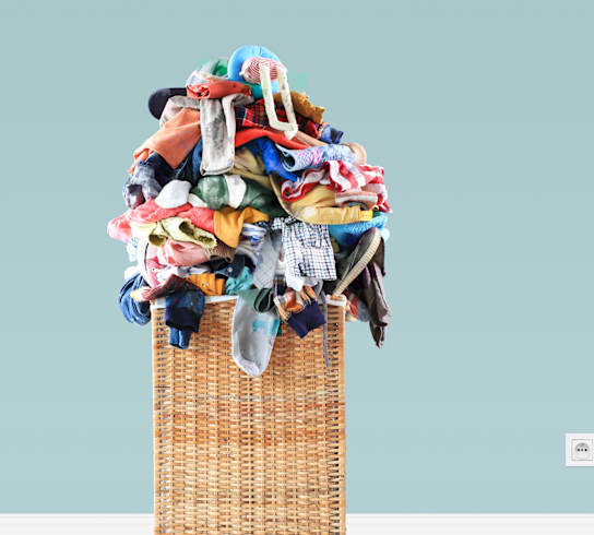 a basket with a pile of clothes on top of it