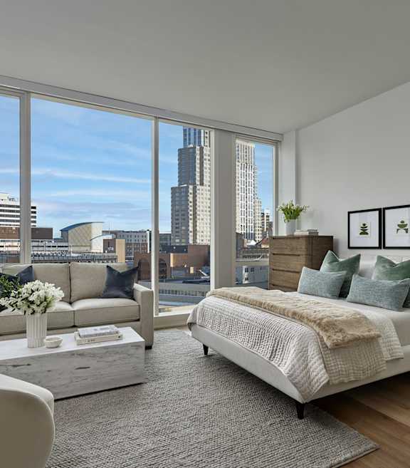 a bedroom with a bed and a window with a city view at AVE Hamilton Green - 25 Cottage Apartments, White Plains , New York