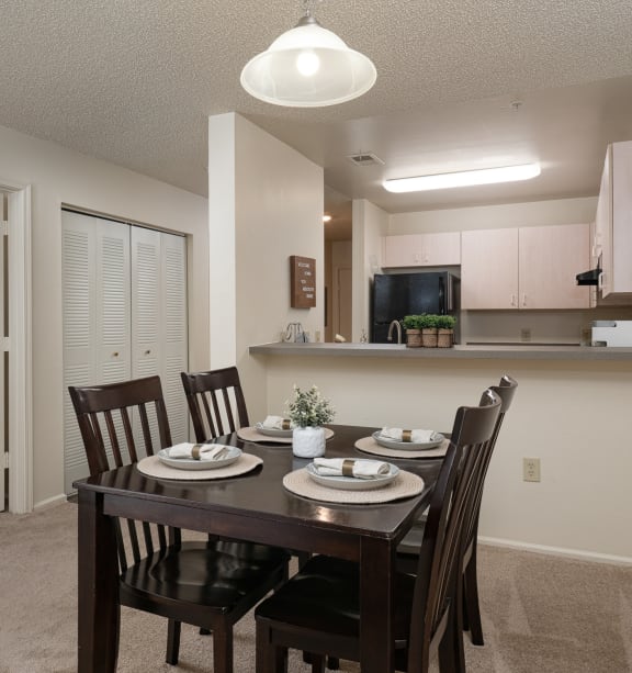 an open kitchen and dining room with a table and chairs at Stoneridge Apartments in FL, 32608