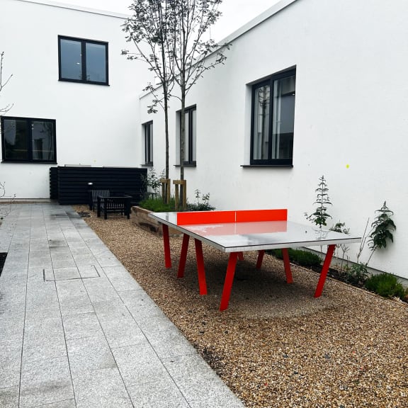a ping pong table in the courtyard of a house