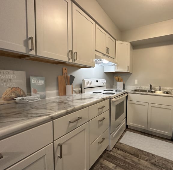 a kitchen with wooden cabinets and a granite counter top