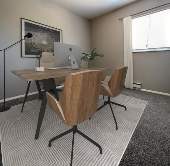 a dining area with a round table and four green chairs