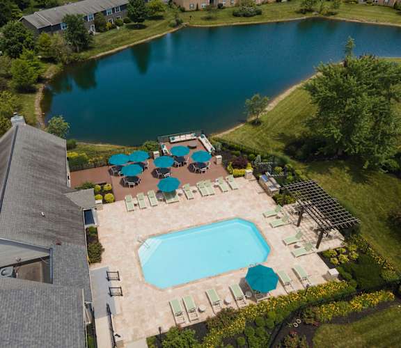 a view of the pool and lake from above
