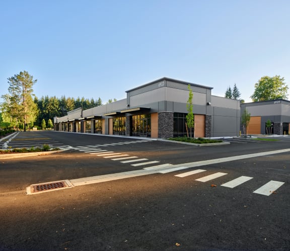 a large white building with a parking lot in front of it