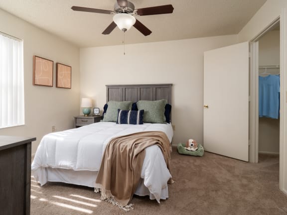 a bedroom with a bed and a ceiling fan at Stoneridge Apartments in Gainesville, FL, 32608