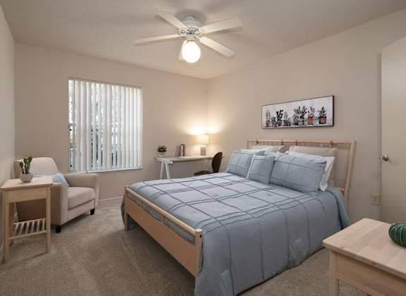 a bedroom with a large bed and a ceiling fan at Tivoli Apartments, Gainesville, FL