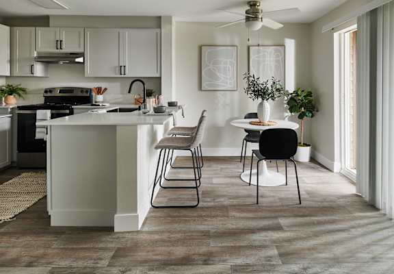 a kitchen with an island and a table with chairs