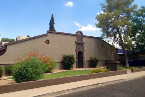 the front of a church with a door and a sidewalk