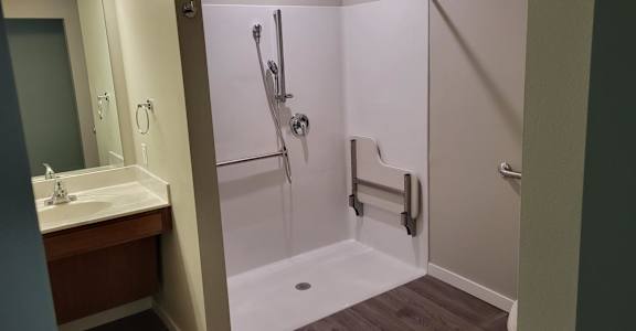 a bathroom with a shower and a sink in it