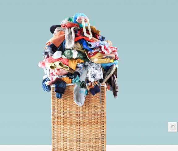 a basket with a pile of clothes on top of it