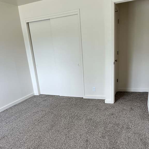 a white cabinet with a drawer next to a wall