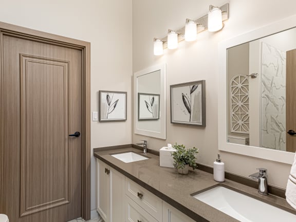 a bathroom with two sinks and a mirror