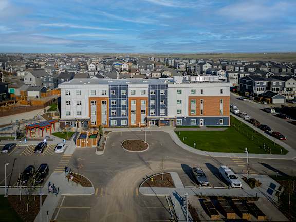 A large building with a parking lot in front of it.