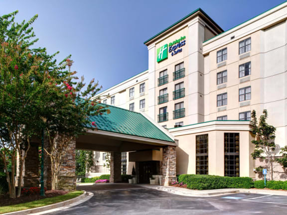 the facade of a hotel building with a green roof