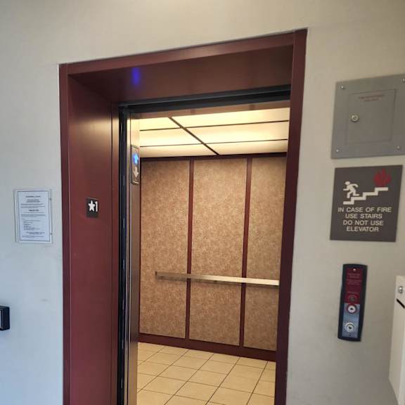 A small room with a fire escape sign on the wall.