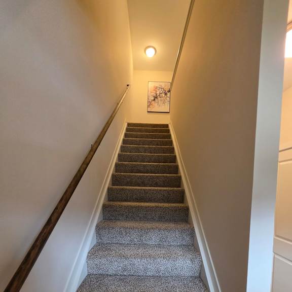 A long hallway with a row of curtains on the side.