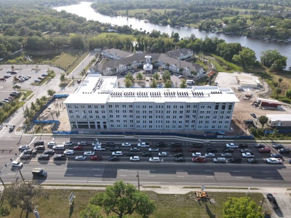 a hotel from above with a parking lot and a river