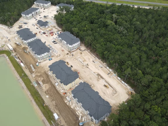 a large building under construction next to a body of water