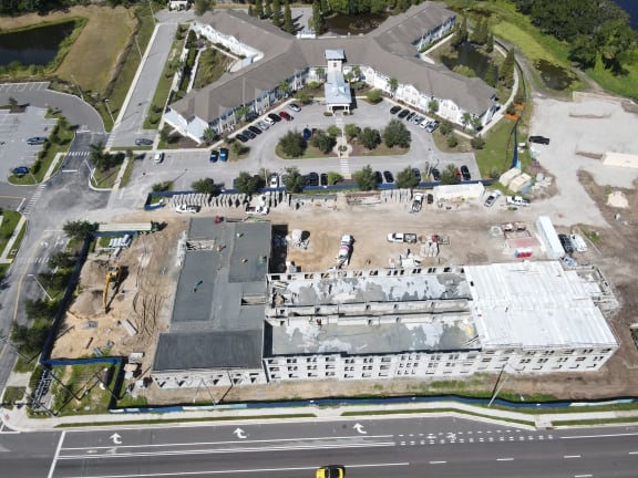 an aerial view of a building under construction in a parking lot