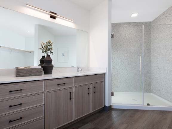 a bathroom with a sink and a shower and a mirror  at AVE Phoenix Sky, Phoenix, Arizona