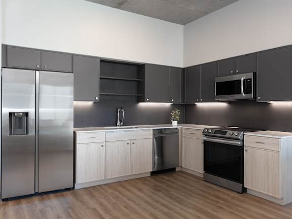 a kitchen with stainless steel appliances and white cabinets at AVE Phoenix Sky, Phoenix, AZ