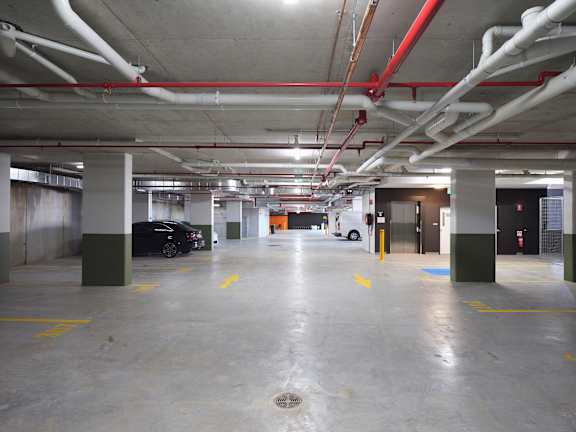 an empty parking garage with a car parked in it