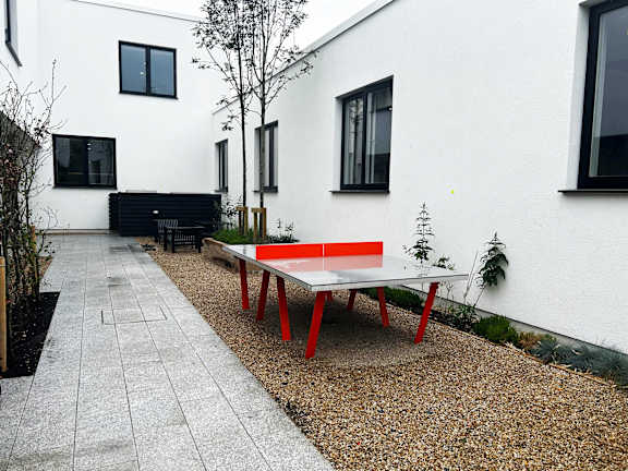 a ping pong table in the courtyard of a house