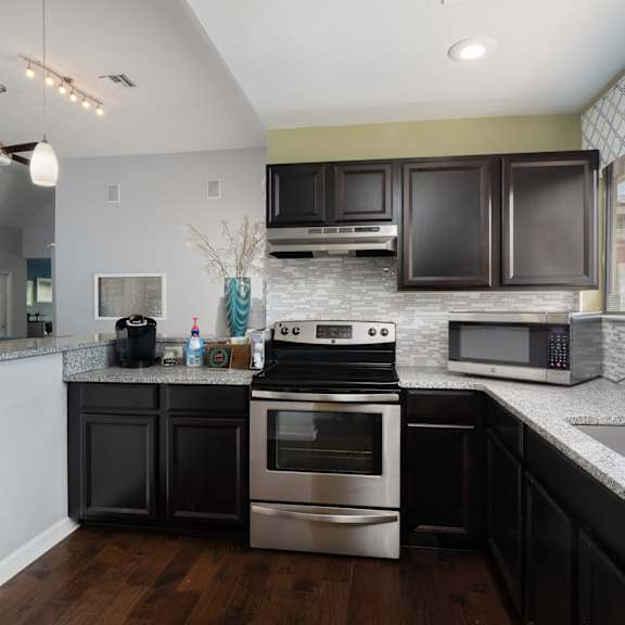 a kitchen with stainless steel appliances and granite counter tops