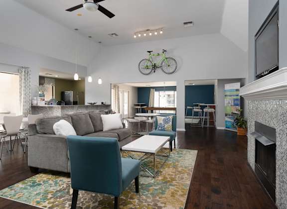 a living room with a couch and a coffee table and a fireplace at Stoneridge Apartments in Gainesville, Florida