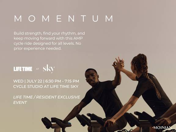 Two people exercising on stationary bikes at Life Time Sky.