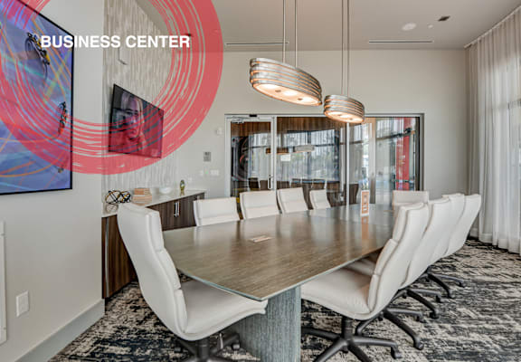 a conference room with a long wooden table and white chairs at Icon One, Daytona Beach