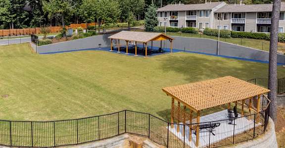 A park area with a pavilion and a fence.