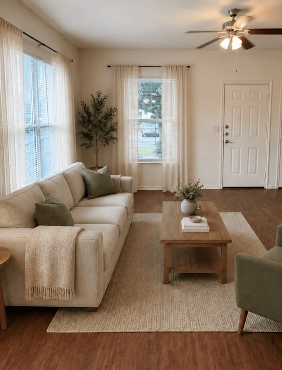 a couch with a blanket on it and a coffee cup on a table